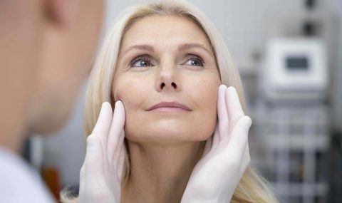 Close-up of a smiling middle-aged woman during aesthetic consultation, representing Metoo dermal filler volume assessment